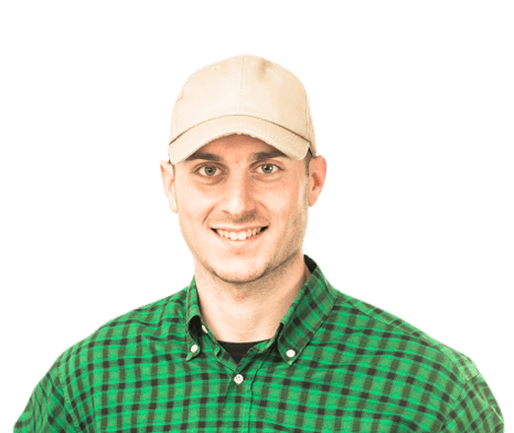 Student Truck Driver smiling in green plaid shirt and hat